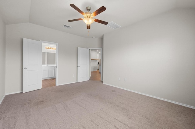 5817 Bell Tower Ln, Austin, TX 78747 - unfurnished bedroom with carpet floors, vaulted ceiling, baseboards, connected bathroom, and ceiling fan