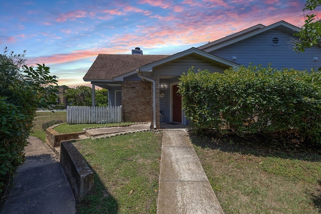 1601 Faro Dr Unit 303, Austin, TX 78741 - view of front of home featuring brick siding, a chimney, and a shingled roof