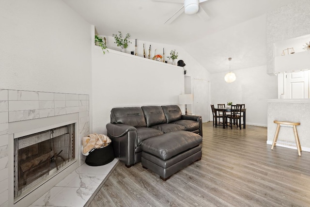 1601 Faro Dr Unit 303, Austin, TX 78741 - living room with a fireplace, lofted ceiling, a ceiling fan, wood finished floors, and baseboards