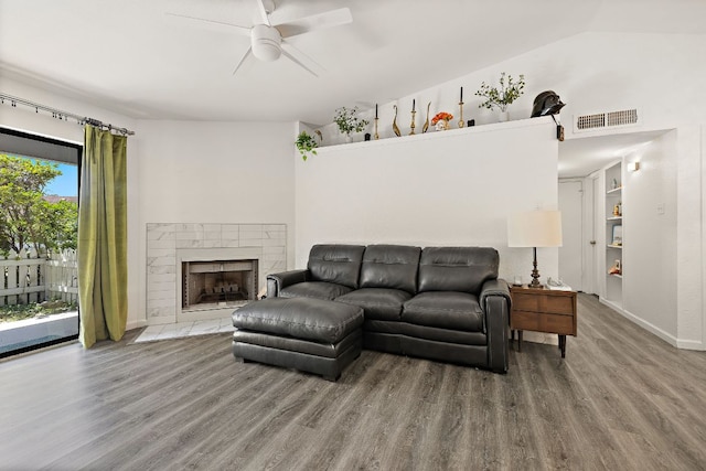 1601 Faro Dr Unit 303, Austin, TX 78741 - living area featuring wood finished floors, a ceiling fan, a fireplace, and baseboards