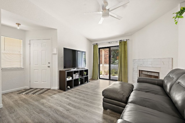 1601 Faro Dr Unit 303, Austin, TX 78741 - living room with wood finished floors, a ceiling fan, vaulted ceiling, baseboards, and a textured wall