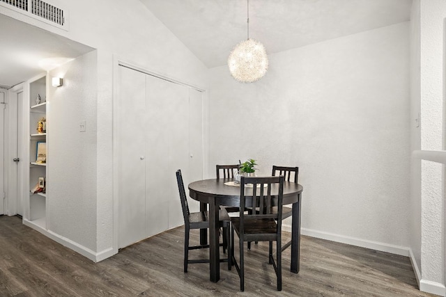 1601 Faro Dr Unit 303, Austin, TX 78741 - dining space with dark wood-type flooring, lofted ceiling, and baseboards