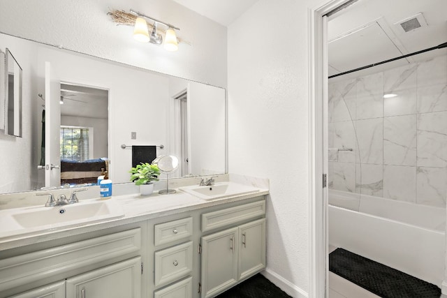 1601 Faro Dr Unit 303, Austin, TX 78741 - ensuite bathroom with double vanity, shower / washtub combination, and a textured wall
