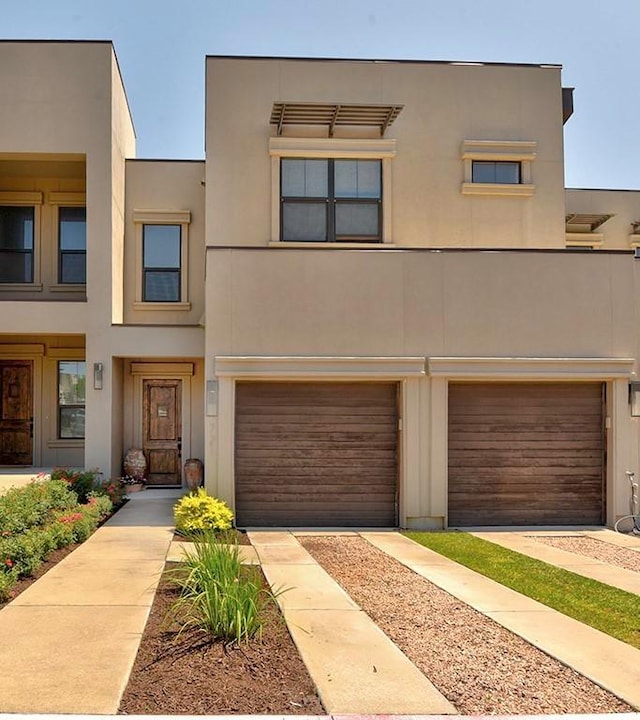 8200 SW Pkwy Unit 721, Austin, TX 78735 - view of front of house with an attached garage and stucco siding