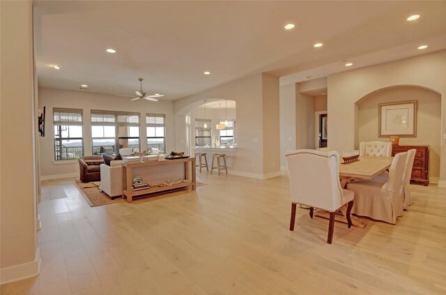 8200 SW Pkwy Unit 721, Austin, TX 78735 - living room with arched walkways, recessed lighting, baseboards, and light wood-style flooring