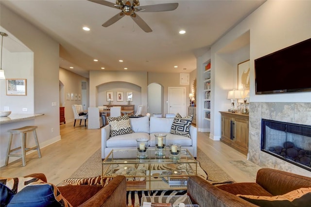 8200 SW Pkwy Unit 721, Austin, TX 78735 - living area featuring ceiling fan, light wood-style flooring, arched walkways, recessed lighting, and a tiled fireplace