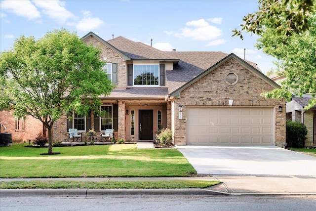 141 Wildcat Draw Dr, Buda, TX 78610 - traditional home featuring driveway, a garage, a front lawn, cooling unit, and a shingled roof