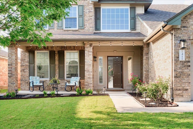 141 Wildcat Draw Dr, Buda, TX 78610 - view of exterior entry featuring a porch, a yard, and roof with shingles