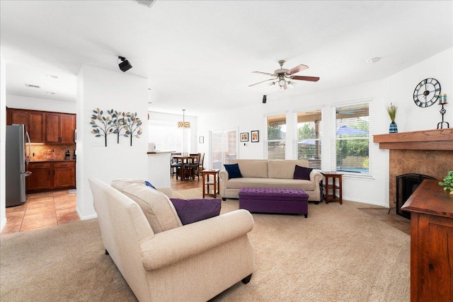 141 Wildcat Draw Dr, Buda, TX 78610 - living area with light carpet, ceiling fan, baseboards, and a premium fireplace