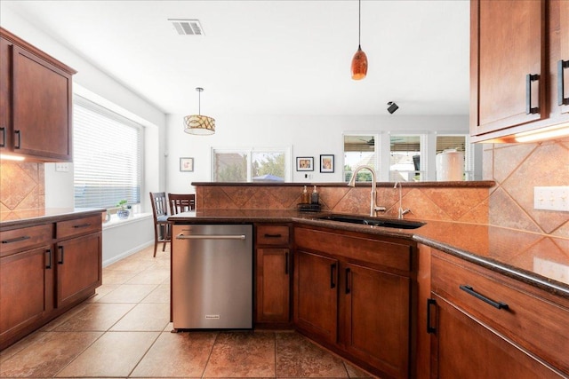 141 Wildcat Draw Dr, Buda, TX 78610 - kitchen featuring stainless steel dishwasher, a sink, healthy amount of natural light, and decorative light fixtures
