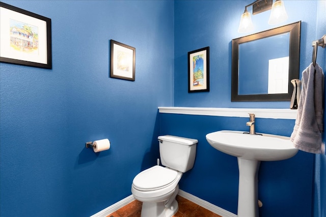 141 Wildcat Draw Dr, Buda, TX 78610 - half bath featuring toilet, baseboards, and tile patterned flooring