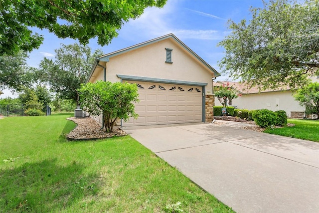 131 Nolan Dr, Georgetown, TX 78633 - view of front of home with stucco siding, a front yard, concrete driveway, and stone siding