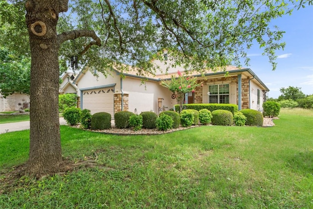 131 Nolan Dr, Georgetown, TX 78633 - view of front of house featuring stone siding, a garage, a front lawn, and stucco siding
