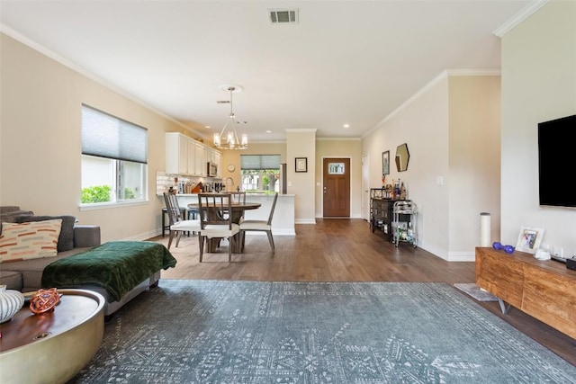 131 Nolan Dr, Georgetown, TX 78633 - dining space with wood finished floors, a chandelier, baseboards, crown molding, and recessed lighting