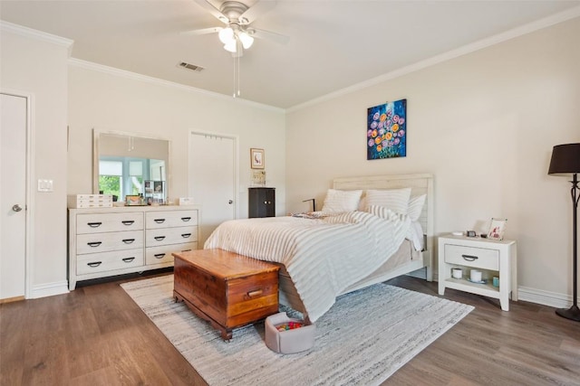131 Nolan Dr, Georgetown, TX 78633 - bedroom with wood finished floors, crown molding, baseboards, and ceiling fan