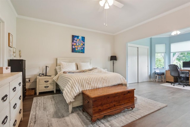 131 Nolan Dr, Georgetown, TX 78633 - bedroom featuring ornamental molding, wood finished floors, a desk, a closet, and ceiling fan