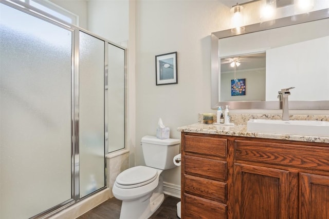 131 Nolan Dr, Georgetown, TX 78633 - full bath featuring vanity, a shower stall, toilet, wood finished floors, and ceiling fan