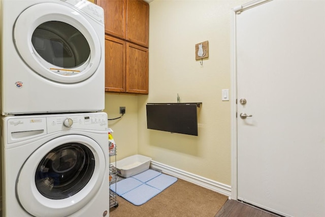 131 Nolan Dr, Georgetown, TX 78633 - laundry room featuring estacked washer and dryer, cabinet space, and baseboards
