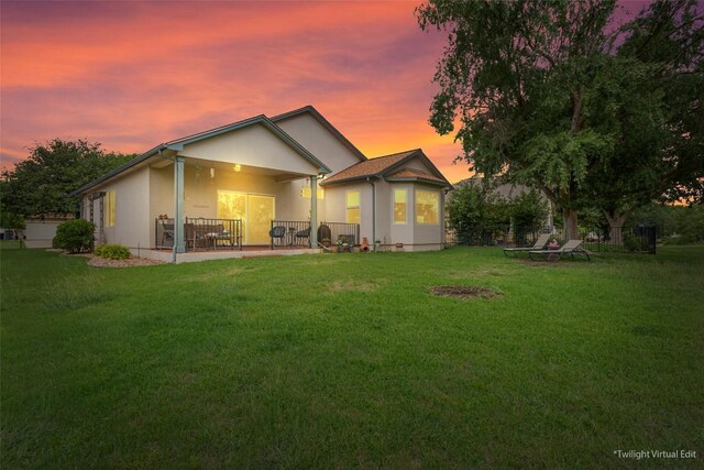 131 Nolan Dr, Georgetown, TX 78633 - back of property at dusk with stucco siding and a patio