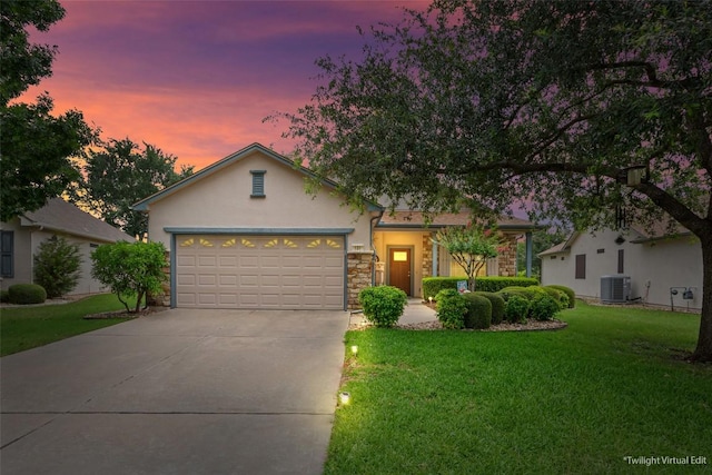 131 Nolan Dr, Georgetown, TX 78633 - view of front of house with stone siding, a yard, an attached garage, stucco siding, and driveway