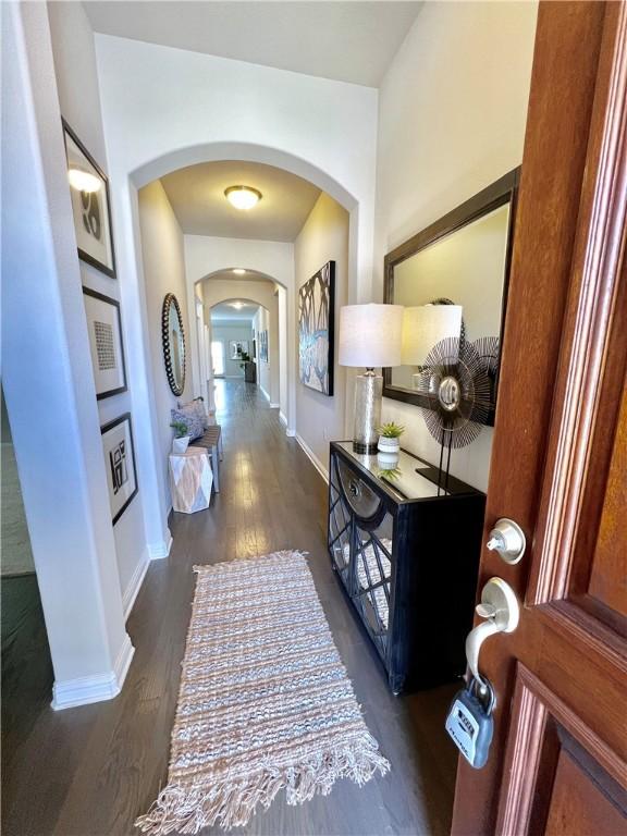 14925 Via Del Corso Dr, Austin, TX 78738 - foyer entrance with arched walkways, wood finished floors, and baseboards