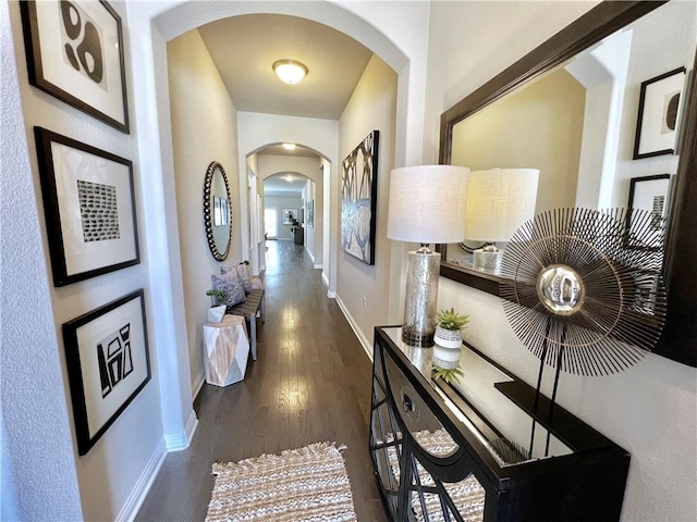 14925 Via Del Corso Dr, Austin, TX 78738 - hallway with arched walkways, baseboards, and dark wood finished floors