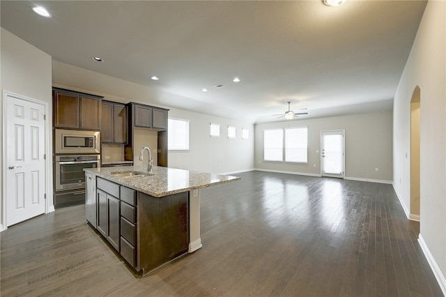 14925 Via Del Corso Dr, Austin, TX 78738 - kitchen with a sink, appliances with stainless steel finishes, ceiling fan, arched walkways, and dark wood-type flooring
