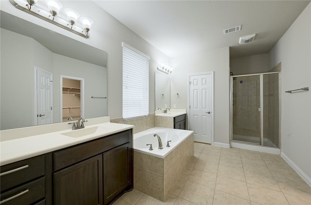 14925 Via Del Corso Dr, Austin, TX 78738 - full bath with a shower stall, vanity, a garden tub, tile patterned flooring, and baseboards