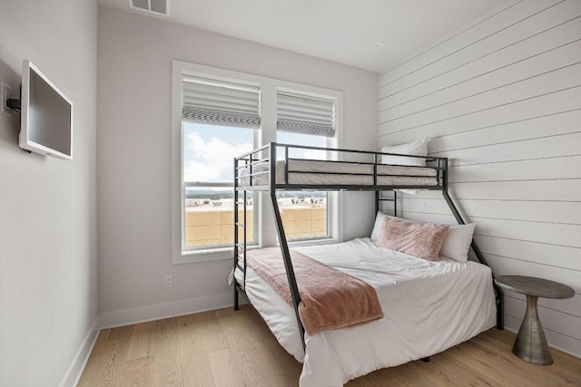 13410 Galleria Cir, Austin, TX 78738 - bedroom with multiple windows, wood finished floors, baseboards, and wood walls