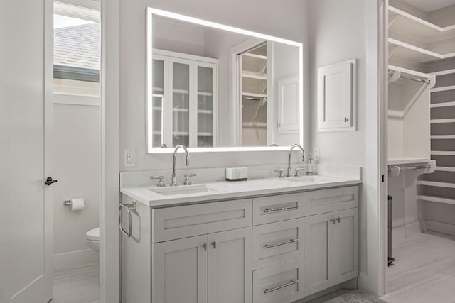 13410 Galleria Cir, Austin, TX 78738 - bathroom with toilet, double vanity, and a walk in closet