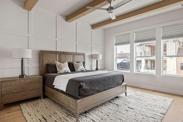13410 Galleria Cir, Austin, TX 78738 - bedroom featuring a decorative wall, beamed ceiling, light wood finished floors, and a ceiling fan