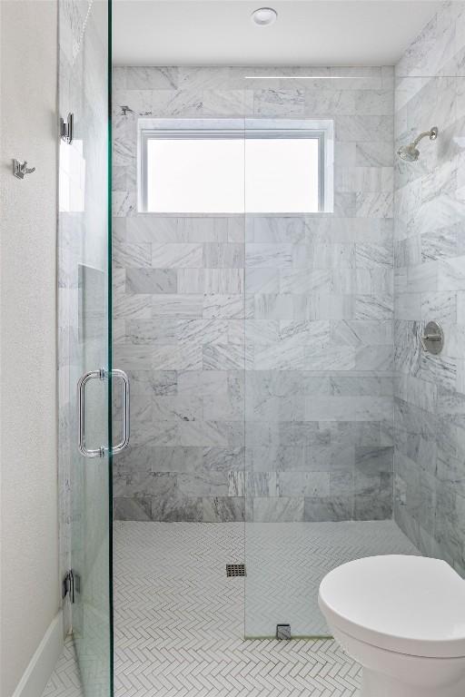 13410 Galleria Cir, Austin, TX 78738 - bathroom featuring healthy amount of natural light, a shower stall, and toilet