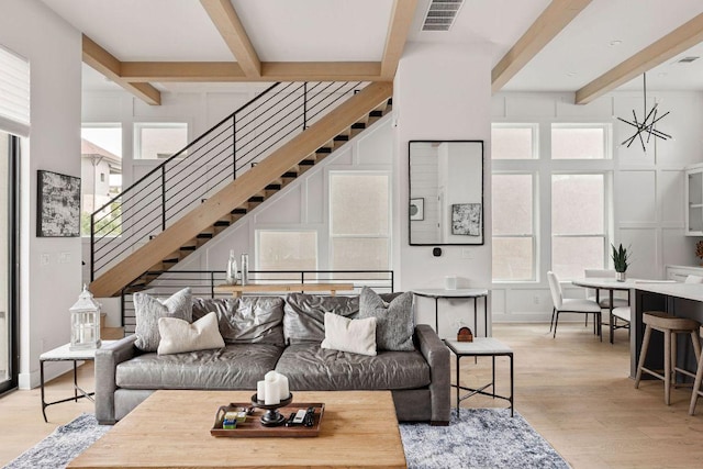 13410 Galleria Cir, Austin, TX 78738 - living area with beam ceiling, light wood-style floors, and stairway