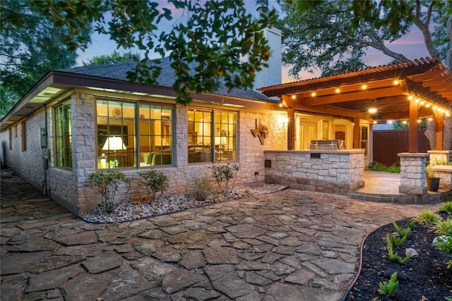 3109 Sesbania Dr, Austin, TX 78748 - patio terrace at dusk featuring an outdoor kitchen and a patio