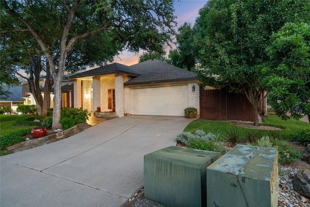 3109 Sesbania Dr, Austin, TX 78748 - view of front of house featuring an attached garage, concrete driveway, and brick siding