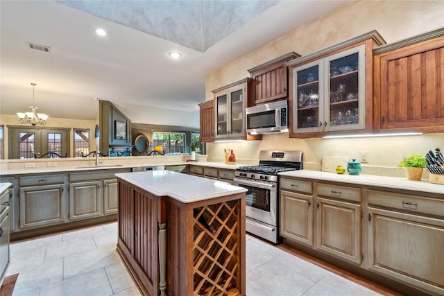 3109 Sesbania Dr, Austin, TX 78748 - kitchen with appliances with stainless steel finishes, a sink, light countertops, a peninsula, and a kitchen island