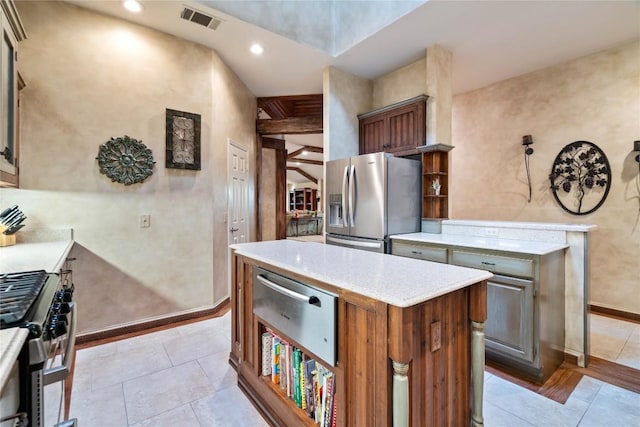 3109 Sesbania Dr, Austin, TX 78748 - kitchen featuring stainless steel appliances, a center island, a warming drawer, light tile patterned floors, and light stone counters