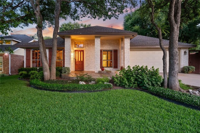3109 Sesbania Dr, Austin, TX 78748 - view of front facade with a garage, a yard, driveway, stone siding, and roof with shingles