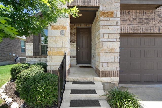 1608 Torre St, Leander, TX 78641 - entrance to property with stone siding, a garage, concrete driveway, and brick siding