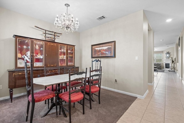 1608 Torre St, Leander, TX 78641 - dining space with a chandelier, light tile patterned flooring, and light carpet