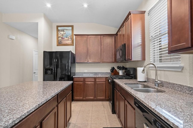 1608 Torre St, Leander, TX 78641 - kitchen featuring black appliances, lofted ceiling, light stone countertops, and light tile patterned floors