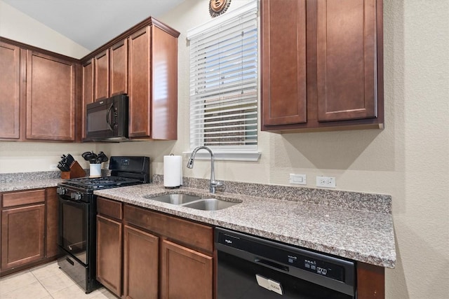 1608 Torre St, Leander, TX 78641 - kitchen featuring black appliances, light tile patterned flooring, and a textured wall