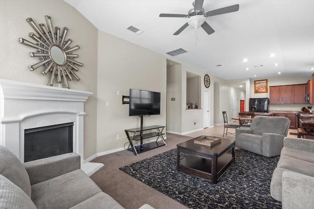 1608 Torre St, Leander, TX 78641 - living room featuring carpet, ceiling fan, vaulted ceiling, a fireplace, and recessed lighting