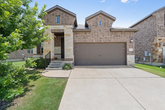 1608 Torre St, Leander, TX 78641 - french country home featuring brick siding, stone siding, an attached garage, concrete driveway, and a front lawn