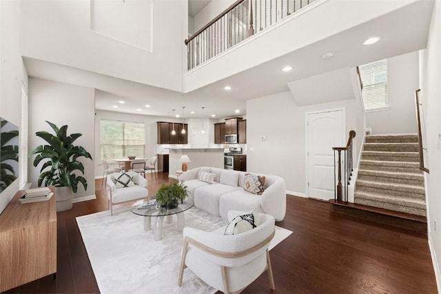 7709 Menchaca Rd Unit 5, Austin, TX 78745 - living area with stairs, dark wood-type flooring, recessed lighting, and a towering ceiling