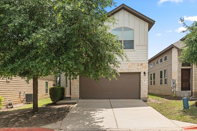 7709 Menchaca Rd Unit 5, Austin, TX 78745 - view of front of home with stone siding, driveway, a garage, and board and batten siding