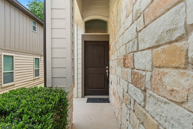 7709 Menchaca Rd Unit 5, Austin, TX 78745 - view of exterior entry featuring stone siding and board and batten siding