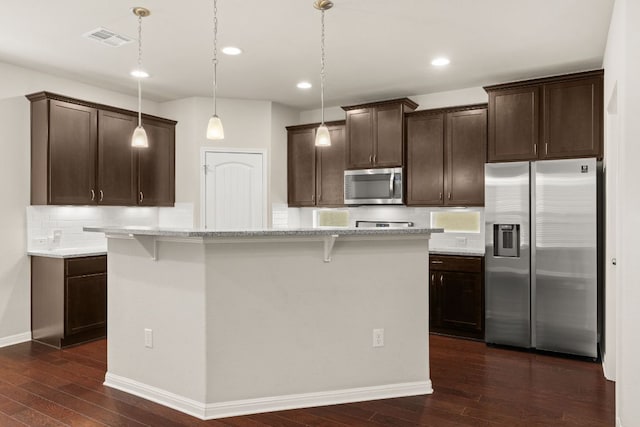 7709 Menchaca Rd Unit 5, Austin, TX 78745 - kitchen featuring stainless steel appliances, dark brown cabinets, dark wood-style flooring, tasteful backsplash, and recessed lighting