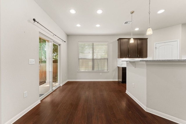 7709 Menchaca Rd Unit 5, Austin, TX 78745 - kitchen featuring recessed lighting, dark wood finished floors, dark brown cabinets, pendant lighting, and light stone countertops