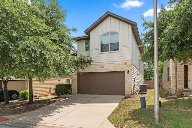 7709 Menchaca Rd Unit 5, Austin, TX 78745 - view of front of house featuring board and batten siding, stone siding, a garage, and concrete driveway